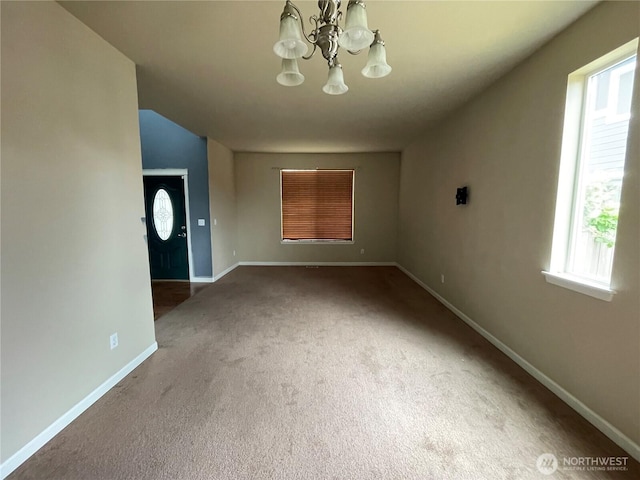 9206 Carys St SE, Yelm, WA 98597 - unfurnished living room with carpet, a chandelier, and plenty of natural light