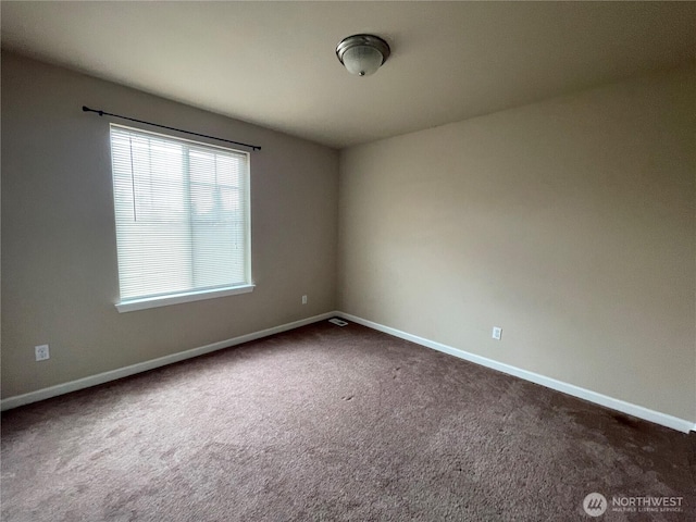 9206 Carys St SE, Yelm, WA 98597 - empty room featuring dark colored carpet and baseboards