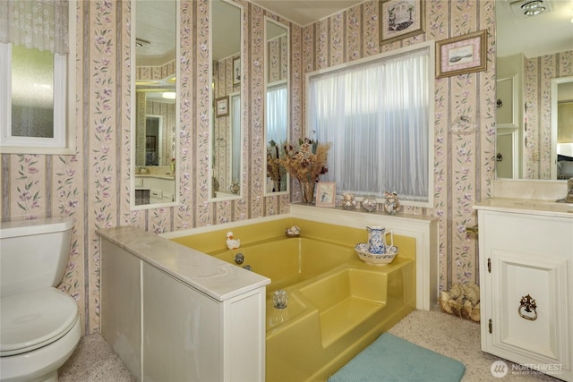 111 Dryke Rd Unit 66, Sequim, WA 98362 - full bathroom with vanity, toilet, a bath, and wallpapered walls