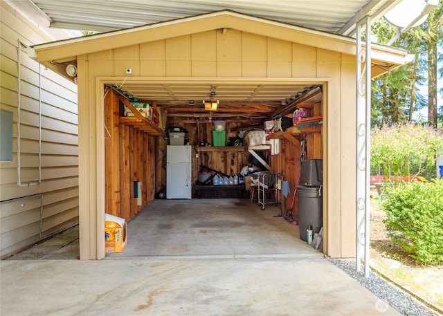 111 Dryke Rd Unit 66, Sequim, WA 98362 - garage featuring freestanding refrigerator and a garage door opener
