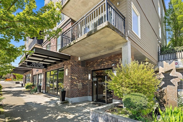1400 N 80th St, Seattle, WA 98103 - view of exterior entry with brick siding and a balcony