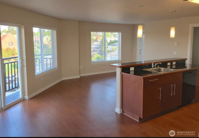 1400 N 80th St, Seattle, WA 98103 - kitchen with dark wood-style flooring, hanging light fixtures, dishwasher, a sink, and baseboards