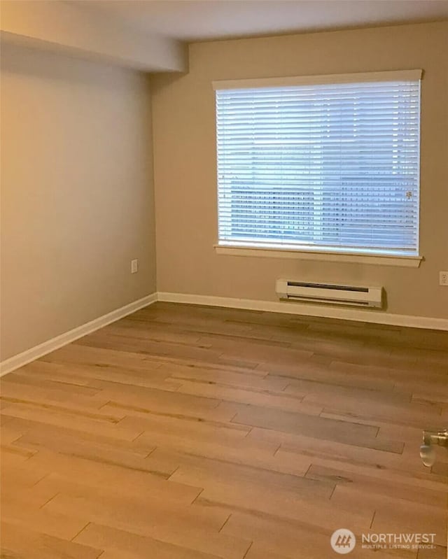 1400 N 80th St, Seattle, WA 98103 - empty room with baseboards, a baseboard radiator, and wood finished floors