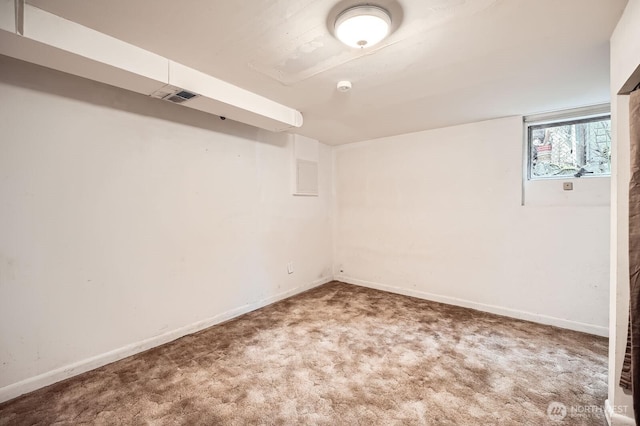 below grade area featuring carpet floors, baseboards, and visible vents