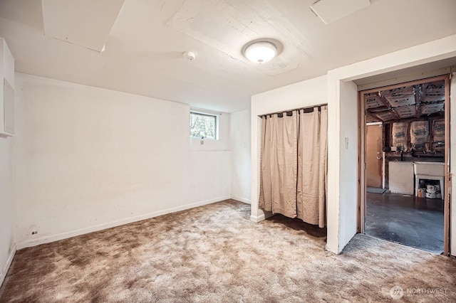 unfurnished bedroom featuring carpet floors, baseboards, and a closet