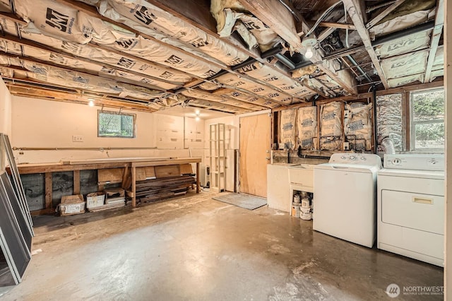 basement with separate washer and dryer, a workshop area, and a healthy amount of sunlight