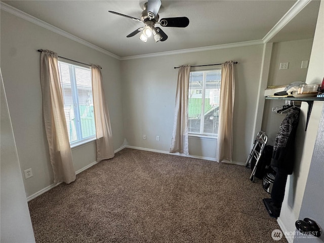 spare room featuring a wealth of natural light, ceiling fan, ornamental molding, and carpet