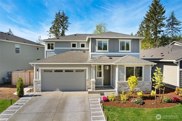 22125 Jameson Ave NW, Poulsbo, WA 98370 - view of front of home with driveway, fence, stone siding, and roof with shingles