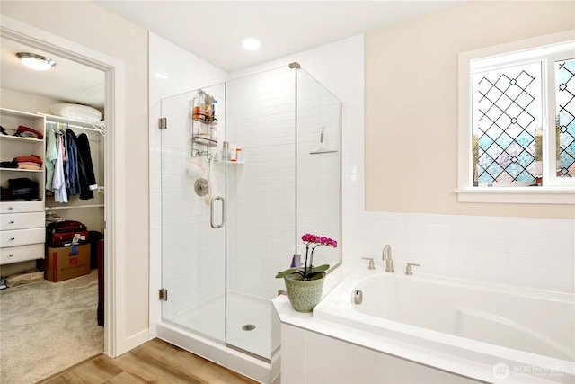 22125 Jameson Ave NW, Poulsbo, WA 98370 - bathroom featuring a stall shower, a bath, a spacious closet, and wood finished floors