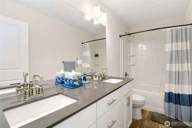 22125 Jameson Ave NW, Poulsbo, WA 98370 - full bathroom featuring double vanity, shower / tub combo with curtain, wood finished floors, and toilet