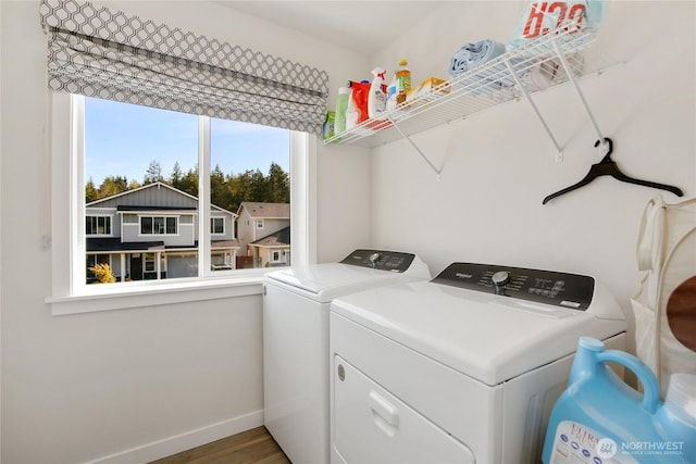 22125 Jameson Ave NW, Poulsbo, WA 98370 - clothes washing area featuring washing machine and clothes dryer, healthy amount of natural light, baseboards, and wood finished floors