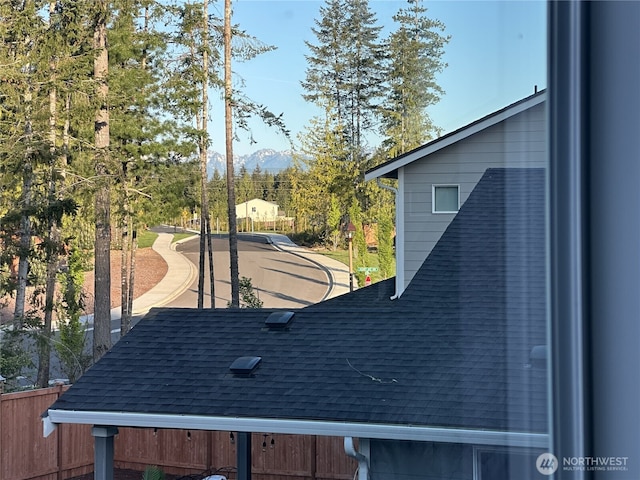 22125 Jameson Ave NW, Poulsbo, WA 98370 - detailed view of a shingled roof, a mountain view, a downspout, and gutters