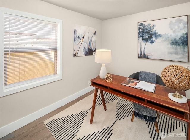 home office with wood finished floors and baseboards
