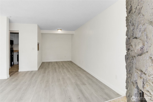 21615 80th Ave W Unit 101, Edmonds, WA 98026 - unfurnished room with baseboards and light wood-type flooring