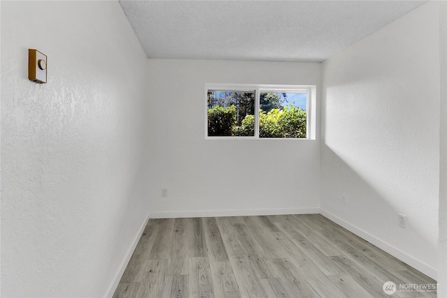 21615 80th Ave W Unit 101, Edmonds, WA 98026 - unfurnished room with baseboards and light wood-style flooring