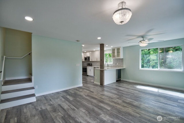 41 SE Wildcat Cove Rd, Shelton, WA 98584 - unfurnished living room featuring ceiling fan, dark wood-style flooring, baseboards, recessed lighting, and a chandelier