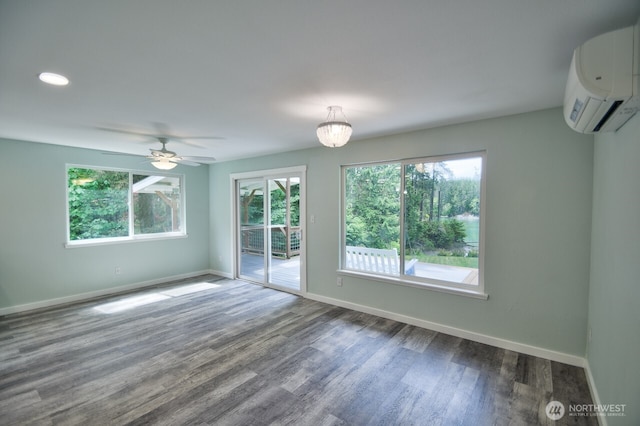 41 SE Wildcat Cove Rd, Shelton, WA 98584 - unfurnished room featuring a wall mounted air conditioner, plenty of natural light, baseboards, and dark wood-type flooring