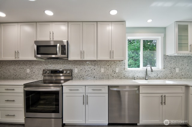 41 SE Wildcat Cove Rd, Shelton, WA 98584 - kitchen featuring stainless steel appliances, a sink, light countertops, white cabinetry, and backsplash