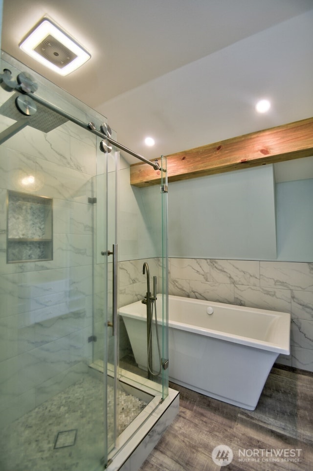 41 SE Wildcat Cove Rd, Shelton, WA 98584 - full bathroom featuring tile walls, a shower stall, a freestanding bath, recessed lighting, and wainscoting