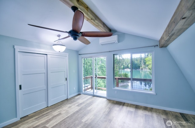 41 SE Wildcat Cove Rd, Shelton, WA 98584 - unfurnished bedroom with a wall mounted AC, access to exterior, wood finished floors, baseboards, and a closet