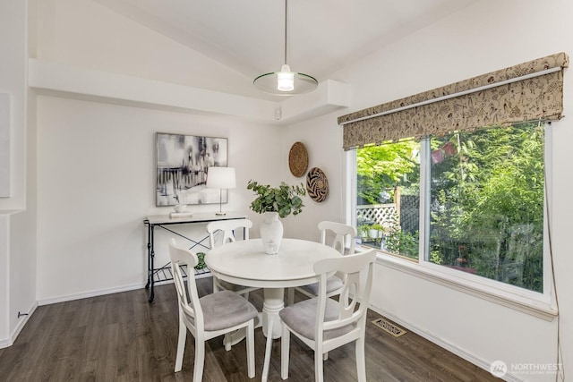 dining space with baseboards, visible vents, dark wood finished floors, and lofted ceiling