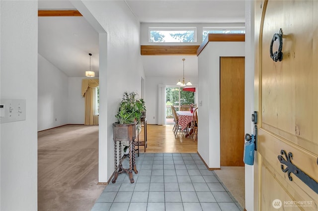 entrance foyer with baseboards and high vaulted ceiling