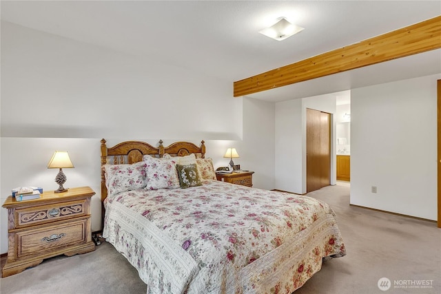 bedroom featuring light carpet, baseboards, and ensuite bath