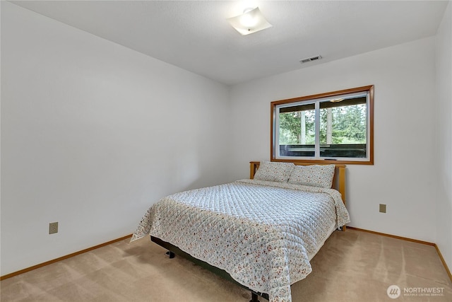 carpeted bedroom with baseboards