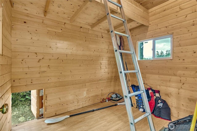 workout area featuring wooden walls, wood ceiling, and wood finished floors