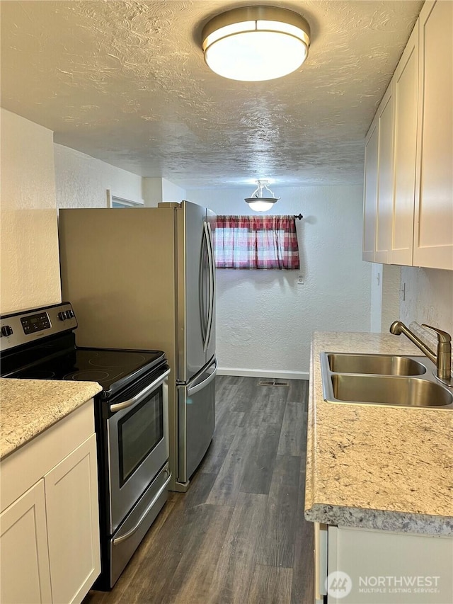 2122 15th St, Bremerton, WA 98312 - kitchen with stainless steel electric stove, a textured ceiling, dark wood-type flooring, and a sink