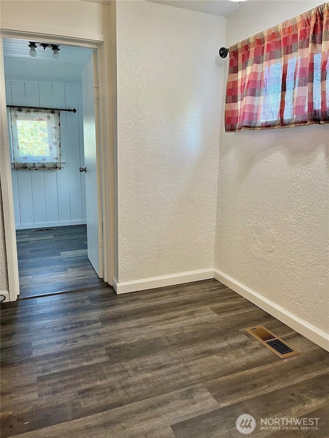 2122 15th St, Bremerton, WA 98312 - spare room with dark wood-type flooring, visible vents, a textured wall, and baseboards