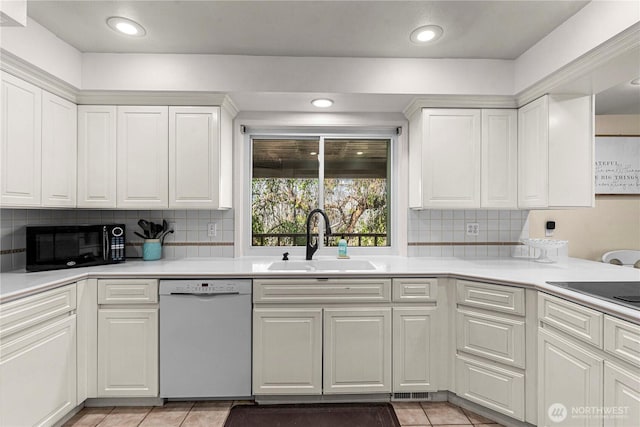 780 10th St NE, East Wenatchee, WA 98802 - kitchen with black appliances, white cabinets, light countertops, decorative backsplash, and light tile patterned floors
