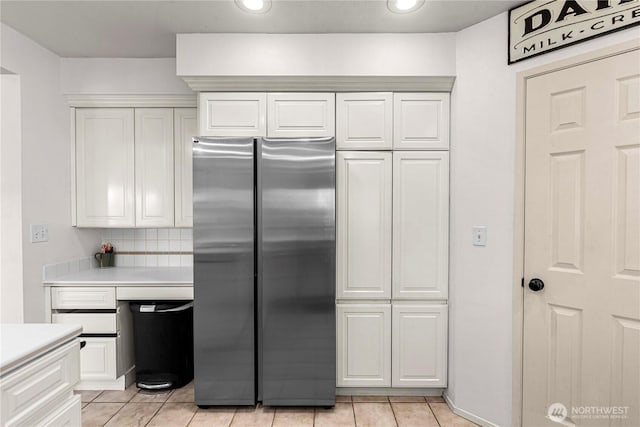 780 10th St NE, East Wenatchee, WA 98802 - kitchen featuring freestanding refrigerator, light countertops, light tile patterned floors, white cabinetry, and recessed lighting