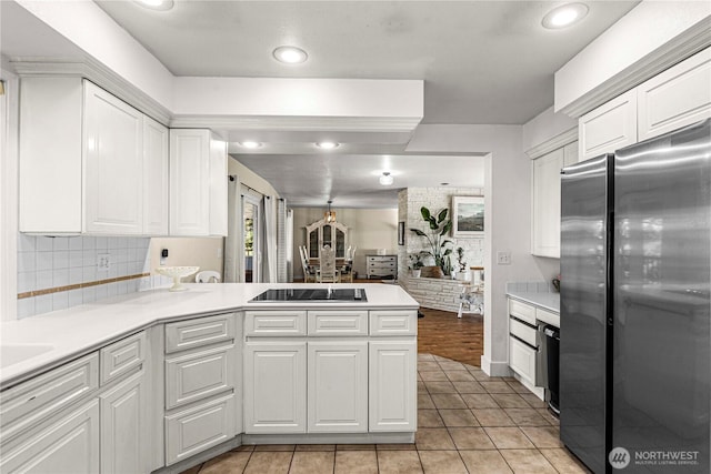 780 10th St NE, East Wenatchee, WA 98802 - kitchen featuring freestanding refrigerator, black electric cooktop, white cabinets, a peninsula, and recessed lighting