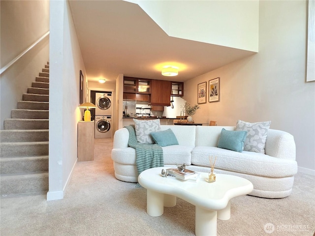 7309 Sand Point Way NE Unit B727, Seattle, WA 98115 - living room featuring stacked washer and clothes dryer, light colored carpet, and baseboards