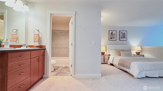 7309 Sand Point Way NE Unit B727, Seattle, WA 98115 - bedroom featuring connected bathroom, a sink, light carpet, and baseboards