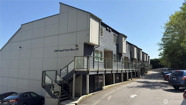 7309 Sand Point Way NE Unit B727, Seattle, WA 98115 - view of building exterior featuring stairs and a residential view