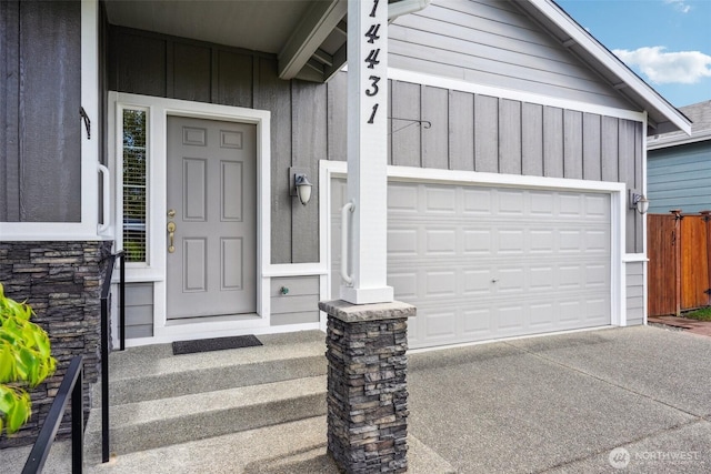 14431 22nd Avenue Ct E, Tacoma, WA 98445 - doorway to property featuring board and batten siding, stone siding, and concrete driveway