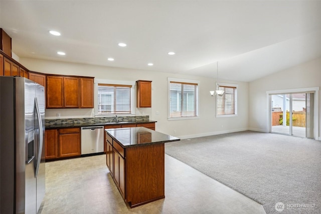 14431 22nd Avenue Ct E, Tacoma, WA 98445 - kitchen with light colored carpet, stainless steel appliances, recessed lighting, a kitchen island, and vaulted ceiling