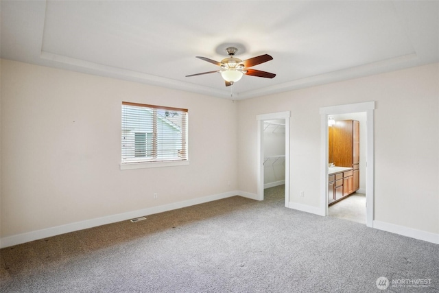 14431 22nd Avenue Ct E, Tacoma, WA 98445 - unfurnished bedroom with a walk in closet, a ceiling fan, baseboards, a closet, and light carpet