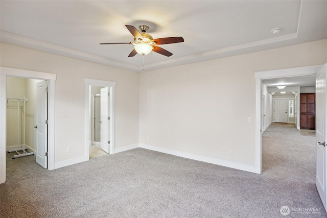 14431 22nd Avenue Ct E, Tacoma, WA 98445 - unfurnished bedroom with baseboards, ensuite bathroom, a walk in closet, light colored carpet, and a ceiling fan