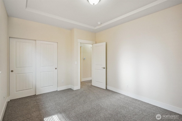 14431 22nd Avenue Ct E, Tacoma, WA 98445 - unfurnished bedroom with a closet, carpet flooring, a raised ceiling, and baseboards