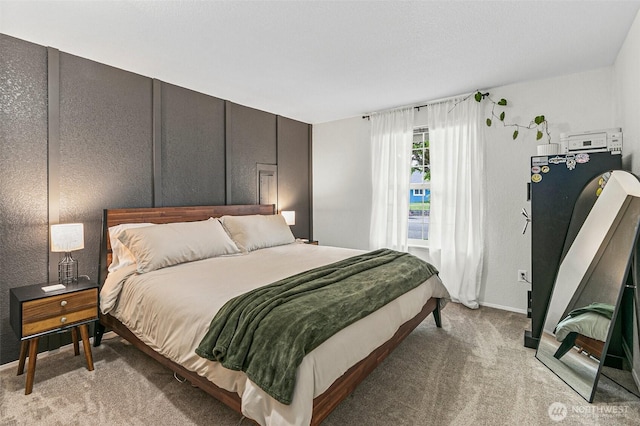 bedroom featuring baseboards and light colored carpet