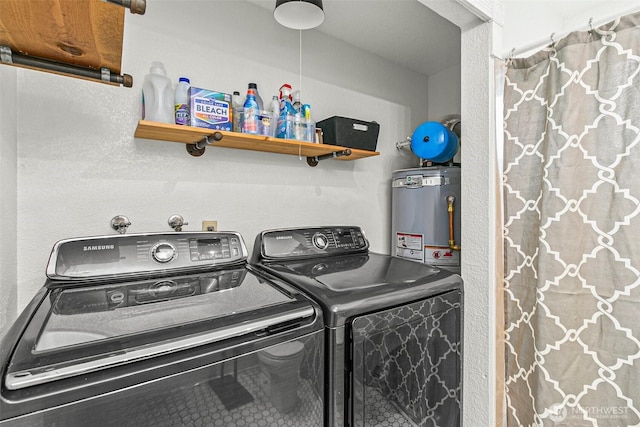laundry area with laundry area, gas water heater, and washing machine and clothes dryer