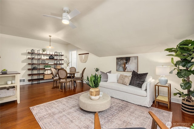 living room featuring visible vents, dark wood finished floors, ceiling fan, and vaulted ceiling