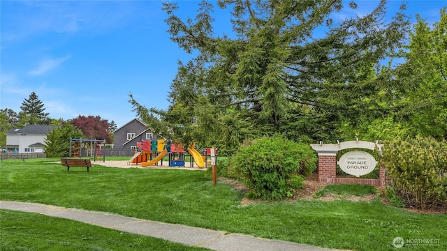 community jungle gym featuring fence and a yard