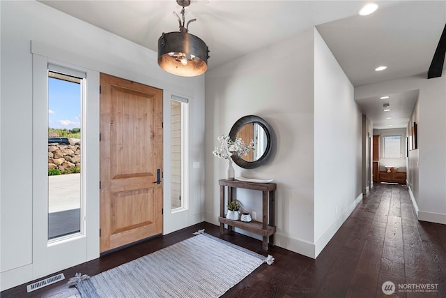 entrance foyer with recessed lighting, visible vents, baseboards, and dark wood finished floors