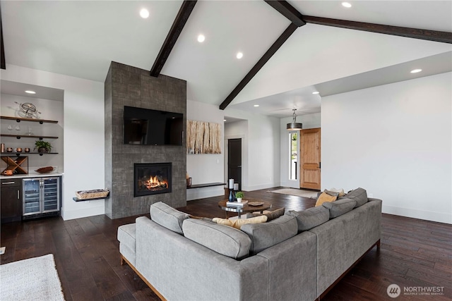 living area featuring high vaulted ceiling, baseboards, beam ceiling, and beverage cooler