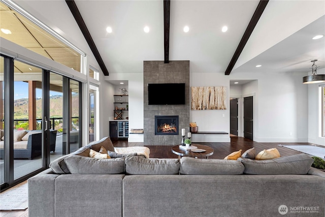 living area with beamed ceiling, recessed lighting, wood finished floors, and baseboards