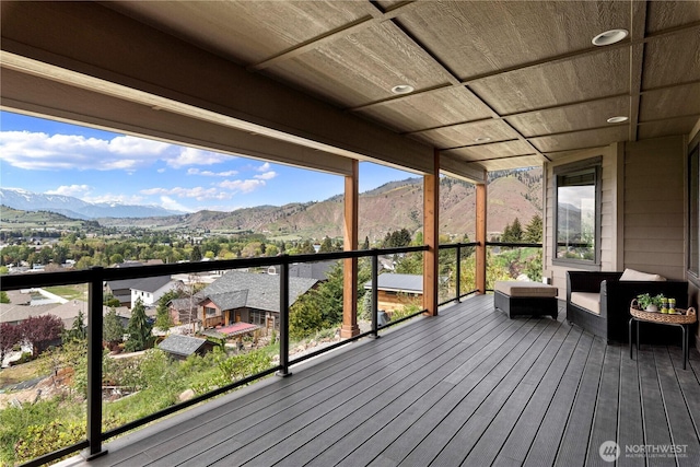 deck with an outdoor living space and a mountain view